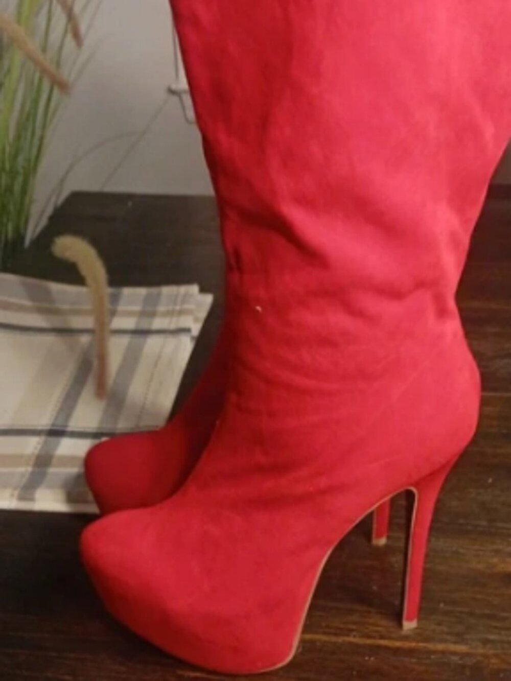 red faux-suede knee-high platform boots featuring a distinctive hidden leopard p